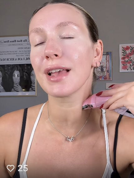 Woman gliding the gua sha neck cream along the side of her neck